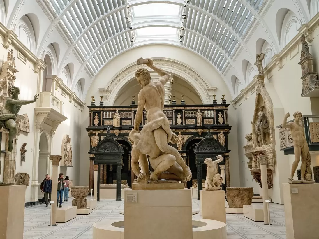 A series of marble figures in an exhibition hall within the V&A Museum, London.