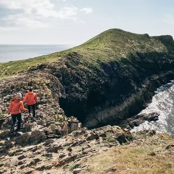Hiking at Rhossili Bay, Wales. attilio pregnolato/Shutterstock