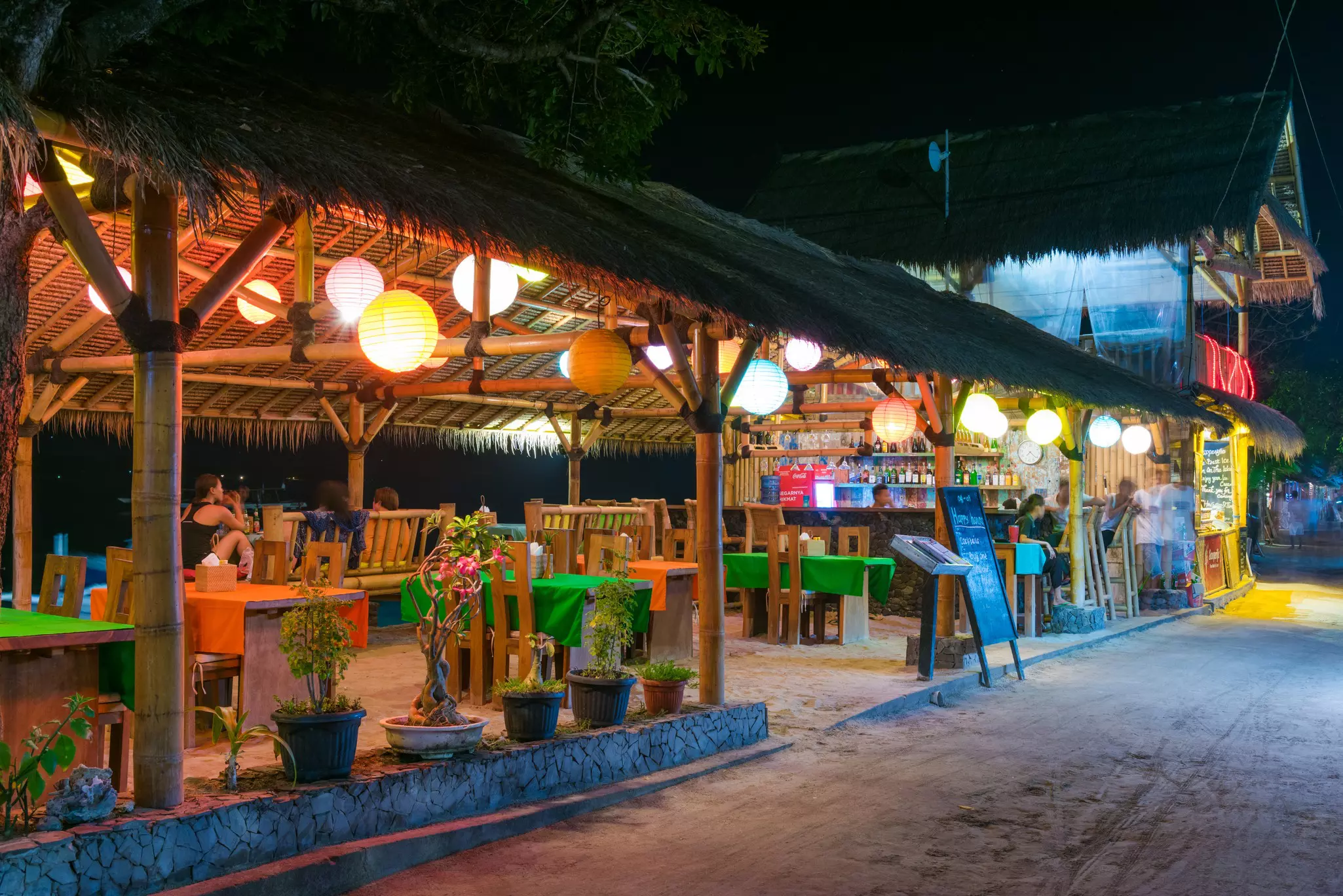 Colorful local tavern on Gili Air island at night.