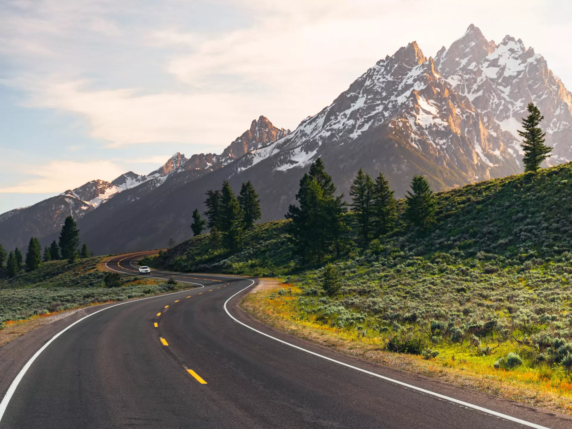 A winding road leads to the Teton Mountain Range at sunset in Grand Teton National Park, Wyoming.,,
{'11': 'Mountain', '12': 'Mountain range', '13': 'Mountains', '14': 'Nature', '15': 'Outdoors', '16': 'Road', '17': 'Scenery', '18': 'Scenic drive', '19': 'Sunlight', '0': 'Grand teton national park', '1': 'Jackson hole', '2': 'Teton', '3': 'Wyoming', '4': 'National park', '5': 'Clouds', '6': 'Drive', '7': 'Golden hour', '8': 'Highway', '9': 'Jackson', '20': 'Sunset', '10': 'Landscape', '21': 'Teton range'}