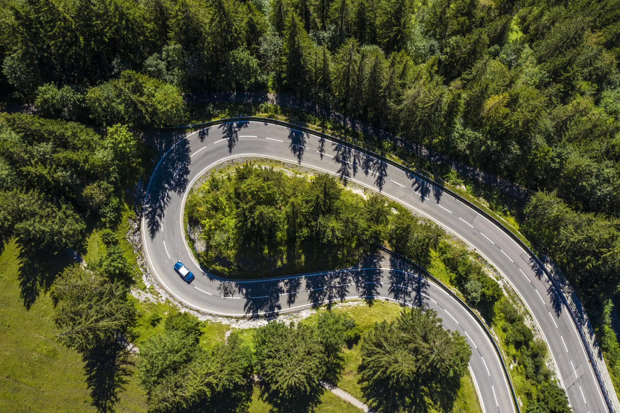 Looking down on a winding road through the Bavarian countryside in Germany with a large switchback