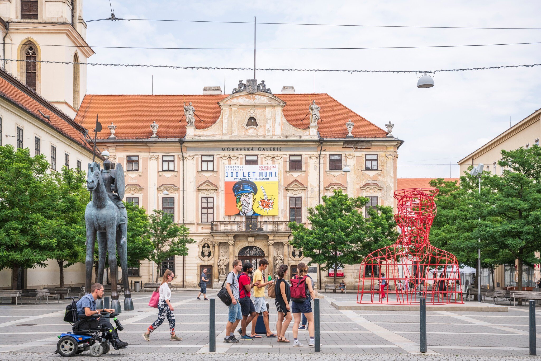 Brno, Czech Republic. Exterior of people walking past the Moravian Gallery (Moravian Museum), the second largest art museum in the Czech Republic.