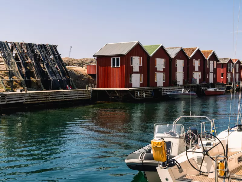 Red boathouses on a waterway.
