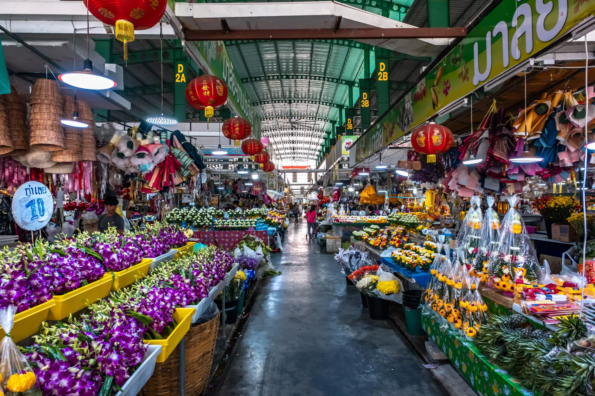 Flowers and orchids line the aisles of the Pak Khlong Flower Market in Bangkok, Thailand.