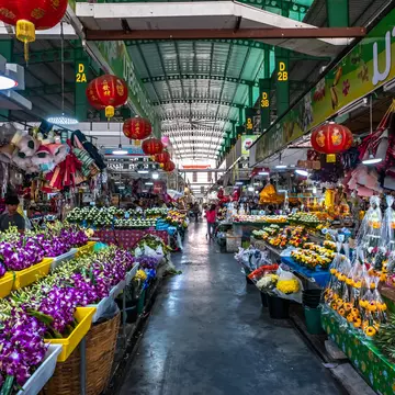 Flowers and orchids line the aisles of the Pak Khlong Flower Market in Bangkok, Thailand.