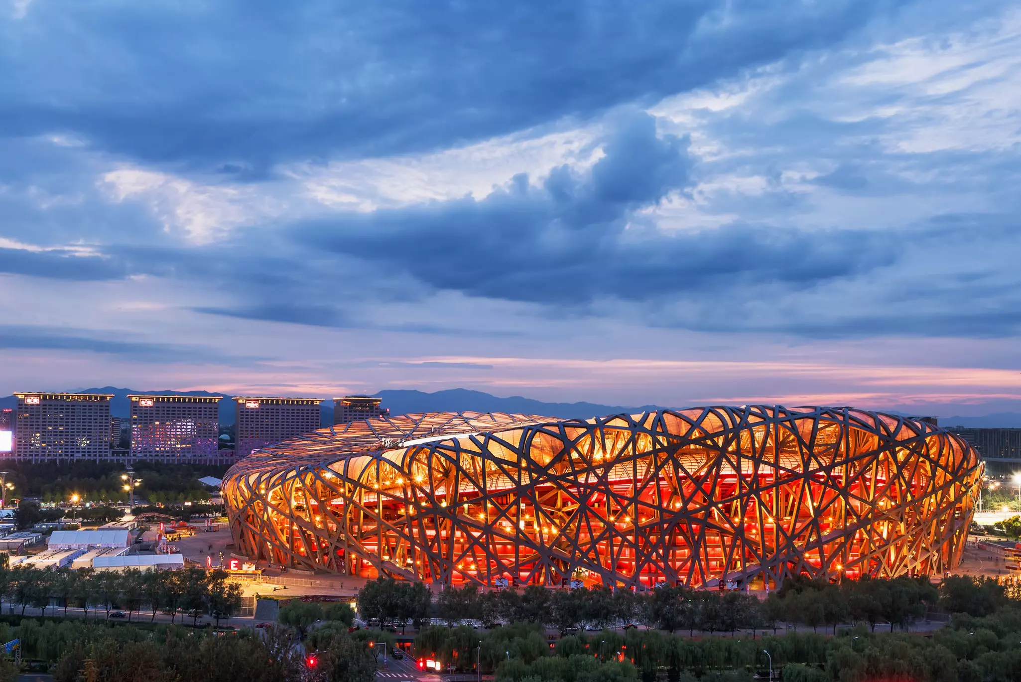 The Beijing National Stadium is illuminated at night.