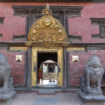 Patan, Nepal - 24 January 2020: Golden door of the temple at Durban square on Patan near Kathmandu in Nepal