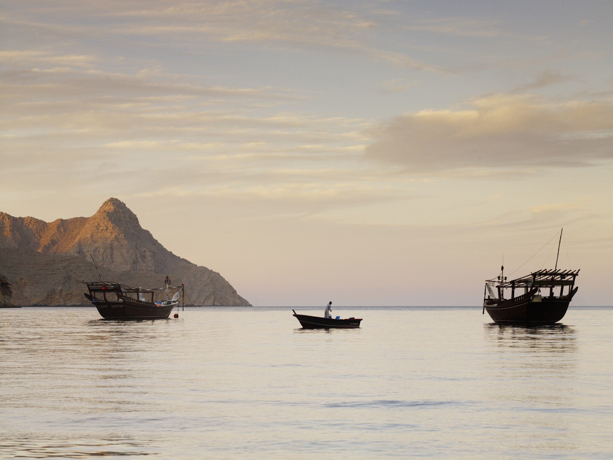 Fishing boats in water at dawn near Kumzar Village.
