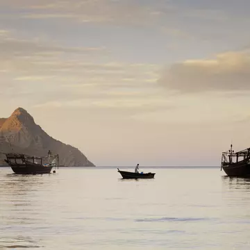 Fishing boats in water at dawn near Kumzar Village.