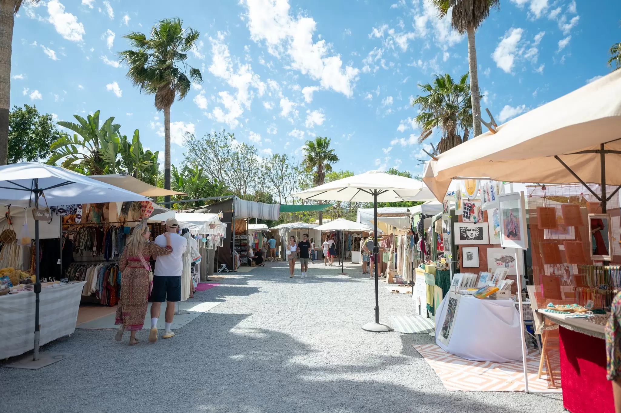 Stalls at a craft market on a sunny day in Ibiza.