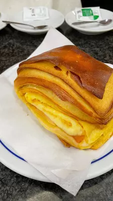 A filled brioche pastry on a white plate.