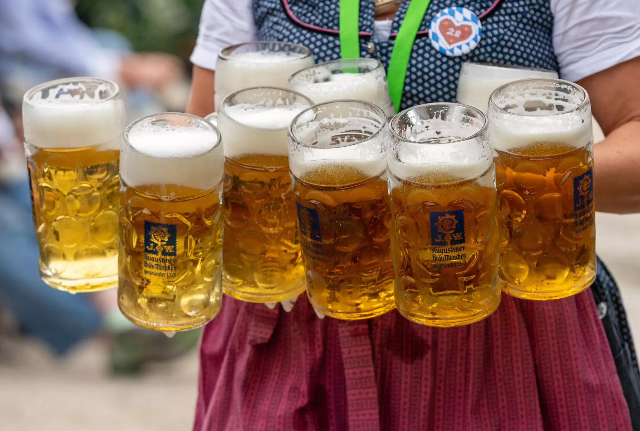 A server carries nine glass steins of beer at the Dachau Volksfest in Bavaria, Germany.