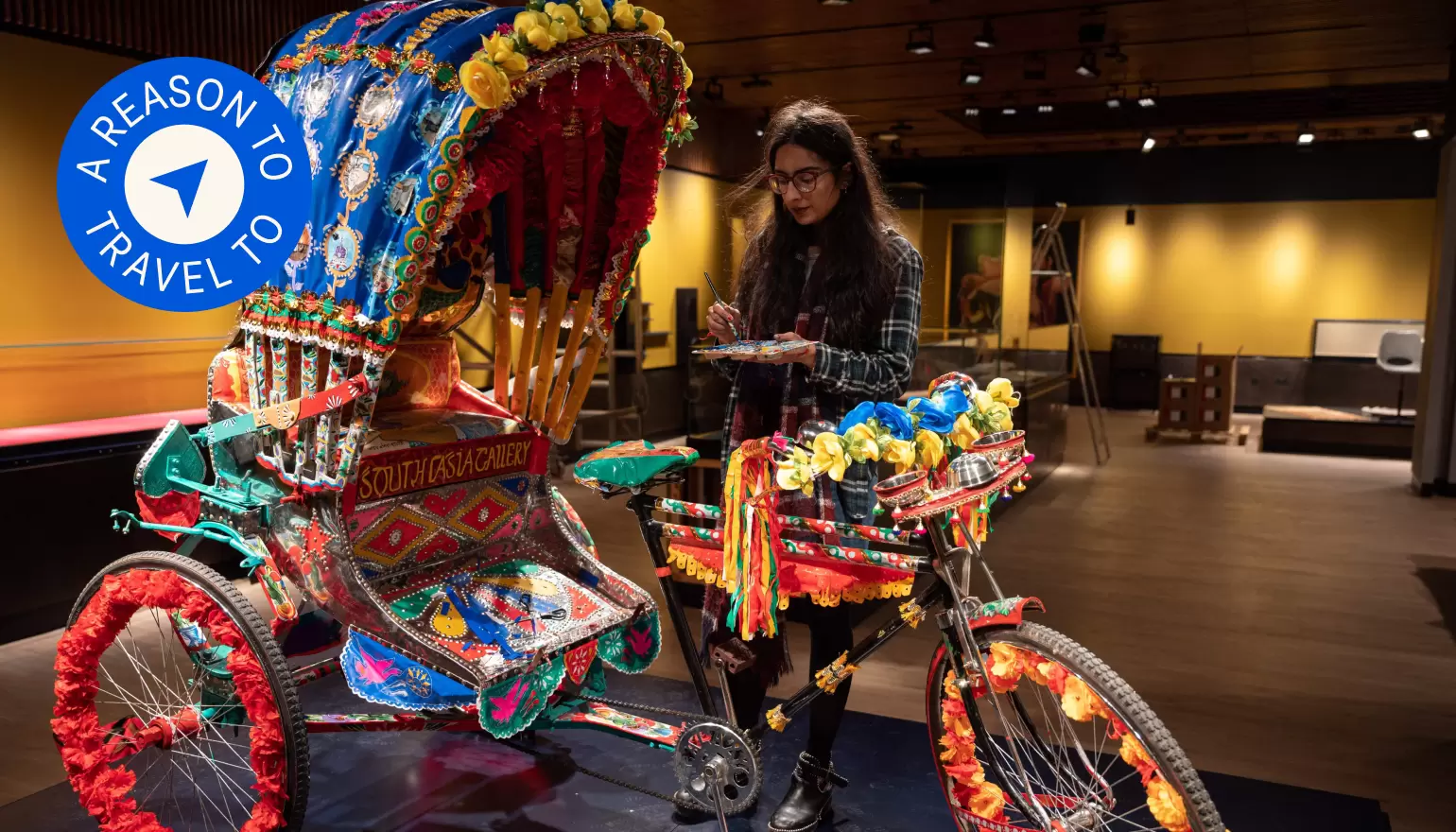 Artist Daya Bhatti puts the finishing touches to a decorated rickshaw artwork which forms part of the South Asia Gallery of Manchester Museum © OLI SCARFF/AFP via Getty Images