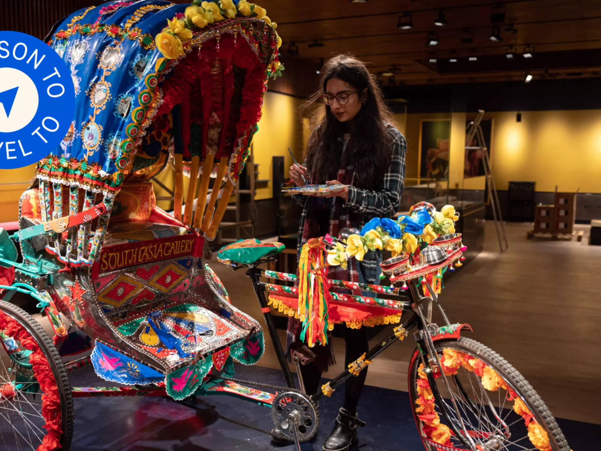 Artist Daya Bhatti puts the finishing touches to a decorated rickshaw artwork which forms part of the South Asia Gallery of Manchester Museum © OLI SCARFF/AFP via Getty Images