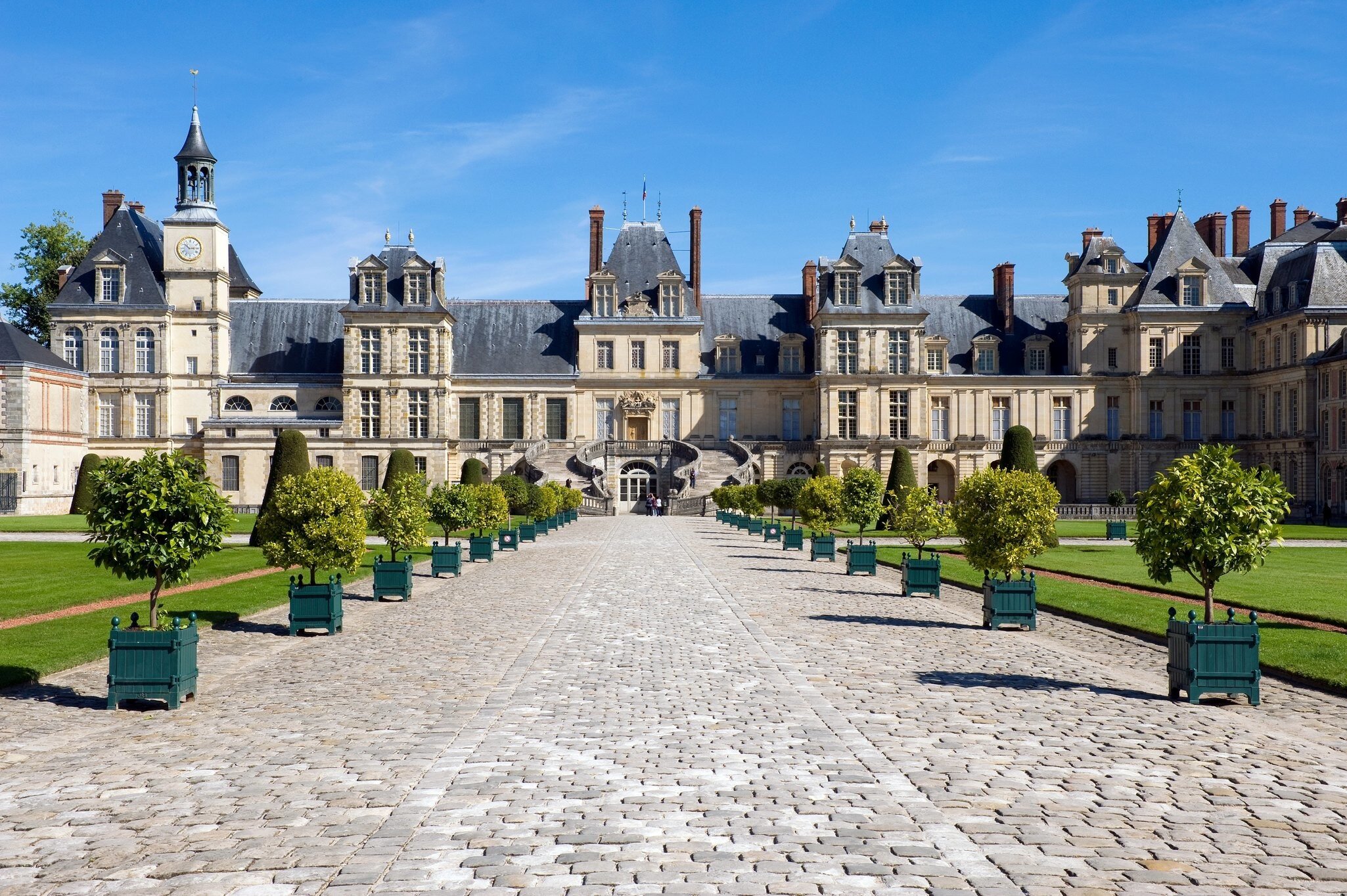 Planter Lined Cobble Stone Pathway Leading to Chateau Fontainebleau, France - stock photo
