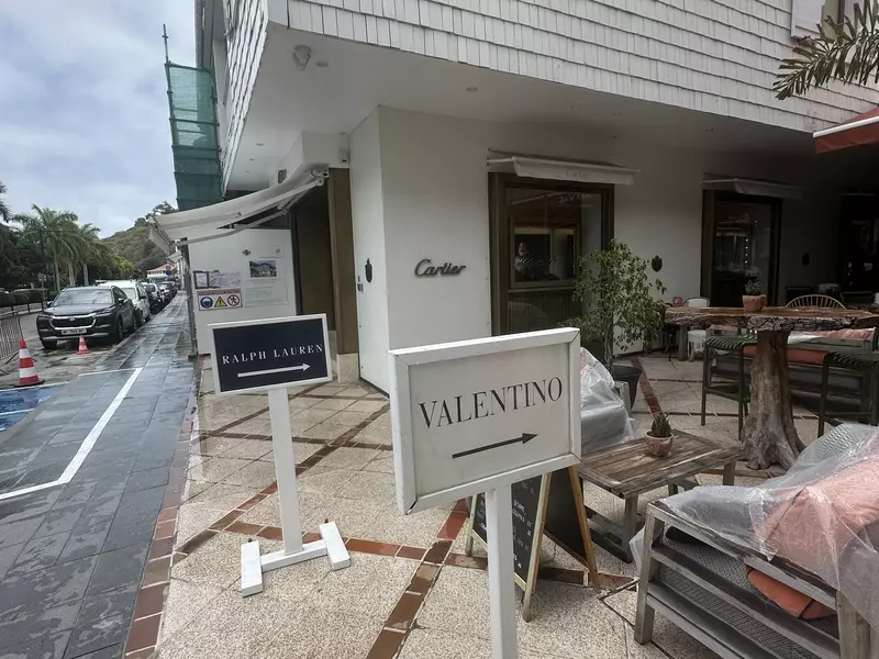 Signs pointing to designer boutiques for Valentino and Ralph Lauren