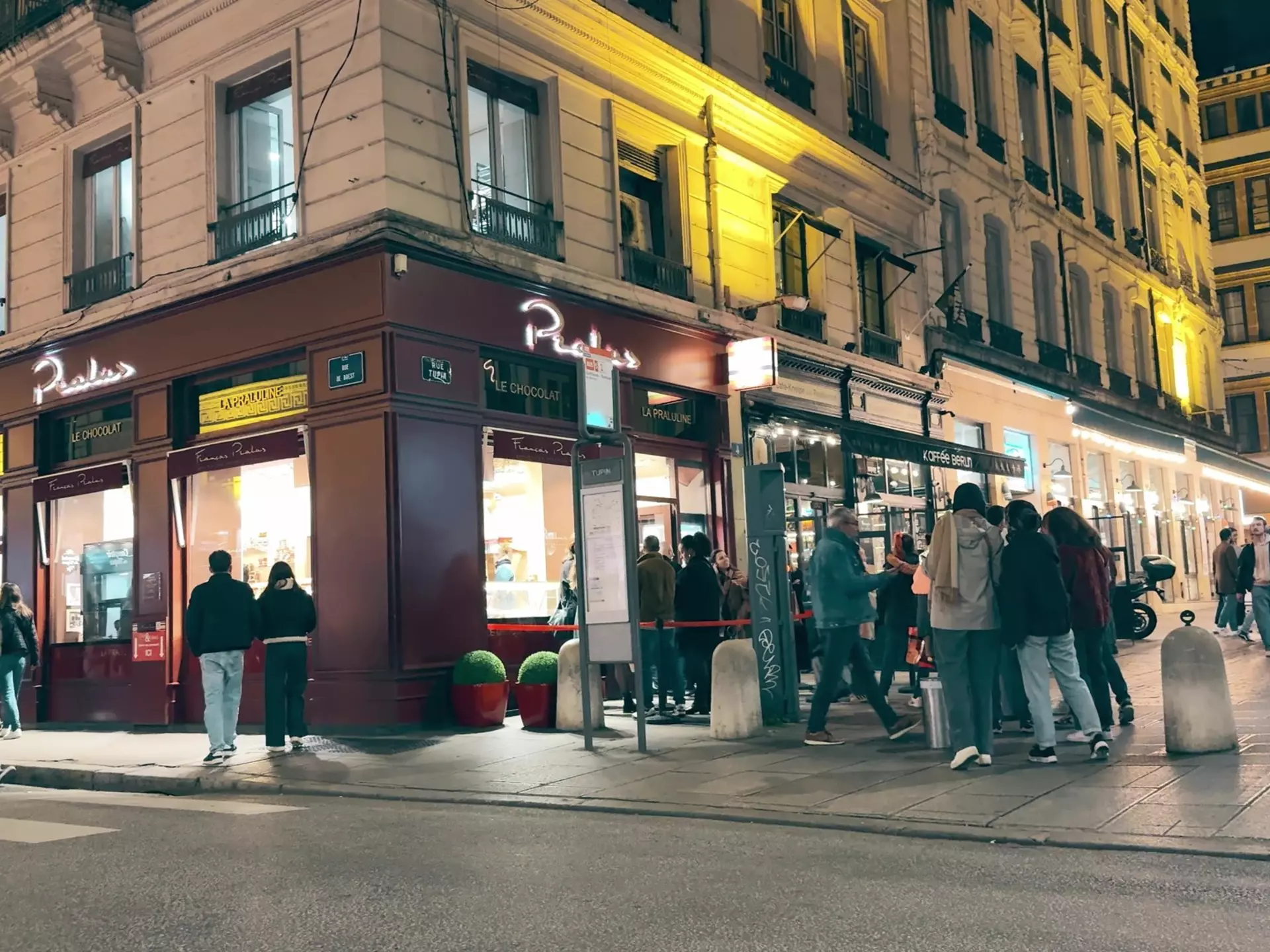 Evening street scene near famous Pralus bakery and patisserie in Lyon, France.