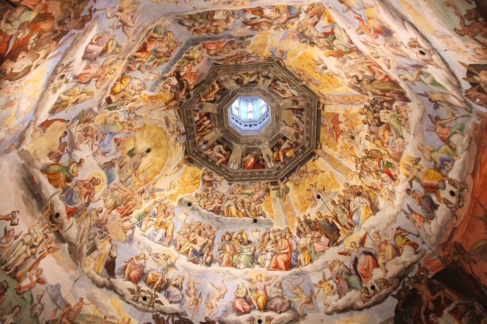An intricate painting on a dome ceiling of biblical scenes