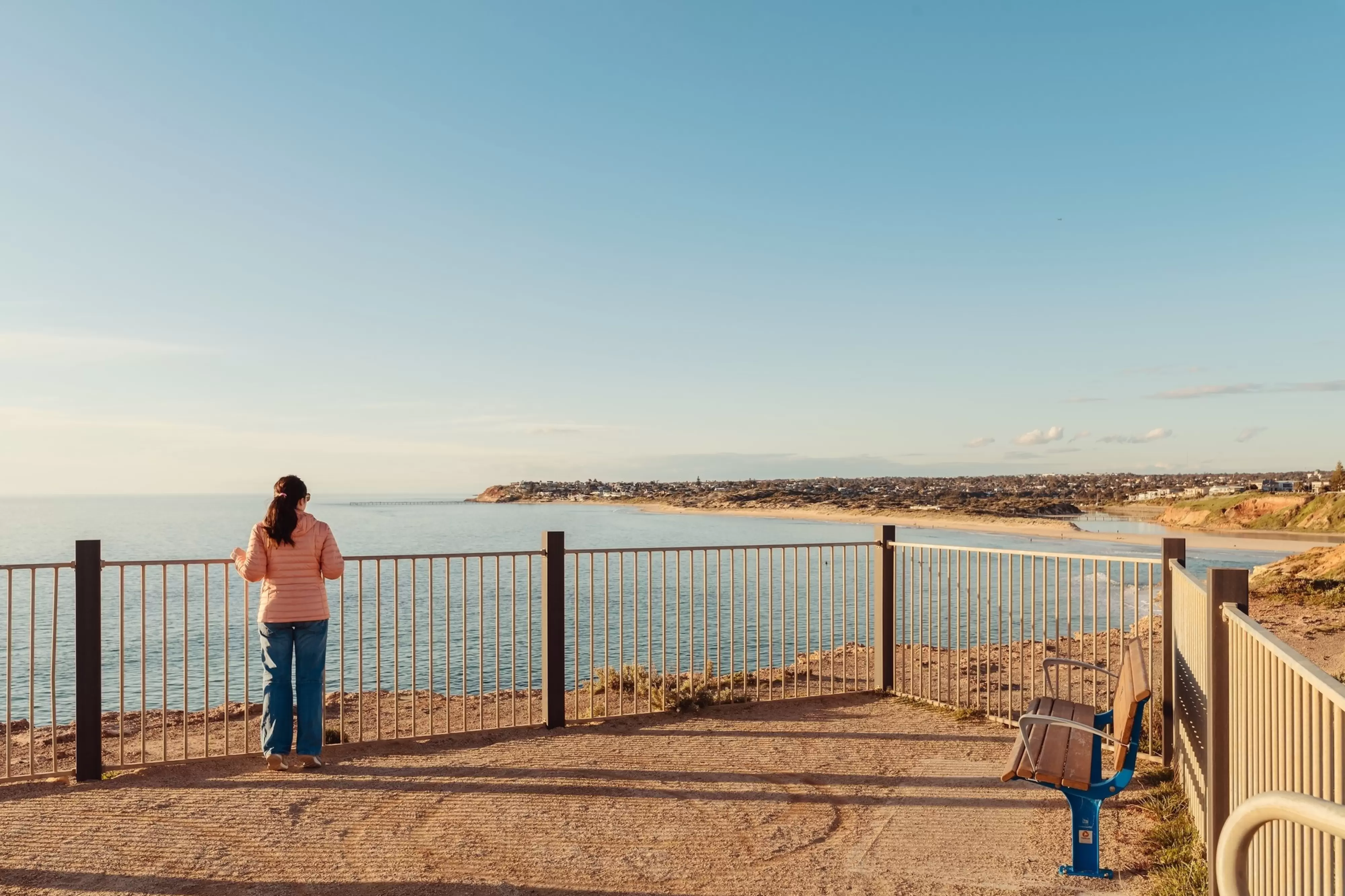 Standing at South Port lookout while enjoying the view towards Port Noarlunga at sunset time, South Australia