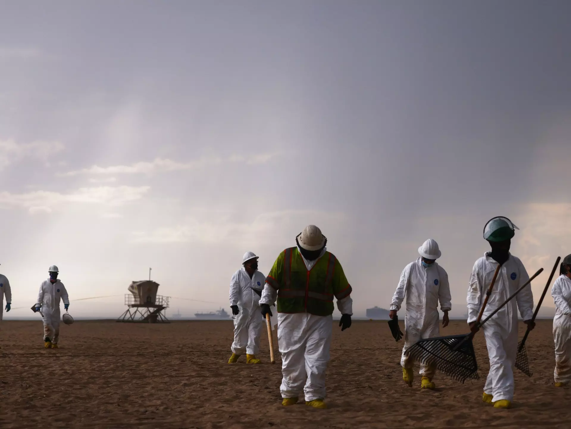 HUNTINGTON BEACH, CALIFORNIA - OCTOBER 04:  Cleanup workers in protective suits depart the closed Huntington State Beach as a storm approaches after a 126,000-gallon oil spill from an offshore oil platform on October 4, 2021 in Huntington Beach, California. The spill forced the closure of the popular Great Pacific Airshow yesterday with authorities closing beaches in the vicinity.  (Photo by Mario Tama/Getty Images)
1344844644
bestof, topix