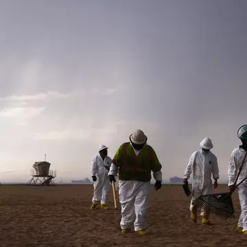 HUNTINGTON BEACH, CALIFORNIA - OCTOBER 04:  Cleanup workers in protective suits depart the closed Huntington State Beach as a storm approaches after a 126,000-gallon oil spill from an offshore oil platform on October 4, 2021 in Huntington Beach, California. The spill forced the closure of the popular Great Pacific Airshow yesterday with authorities closing beaches in the vicinity.  (Photo by Mario Tama/Getty Images)
1344844644
bestof, topix