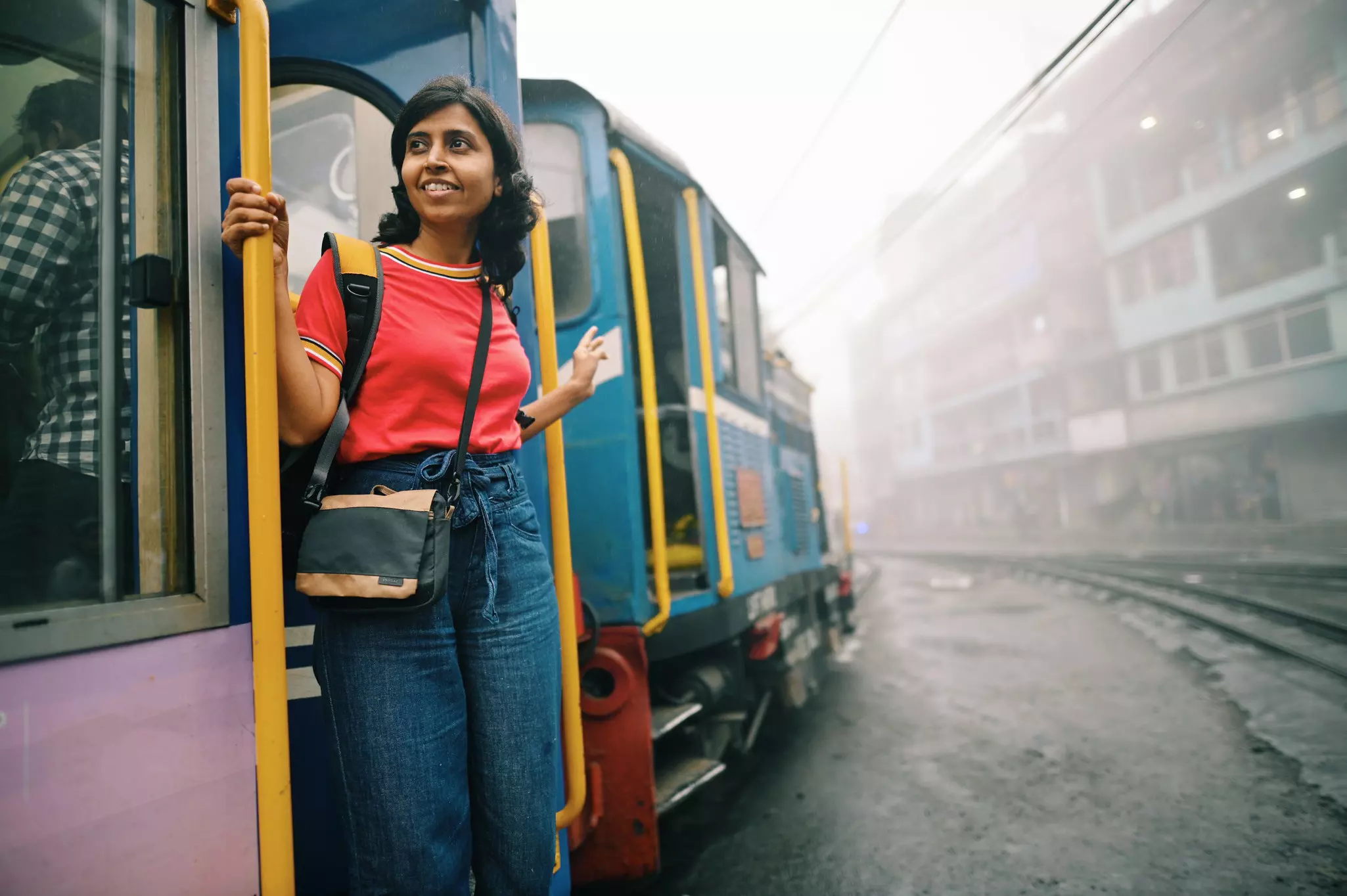 Woman standing at a tourist train door in Darjeeling