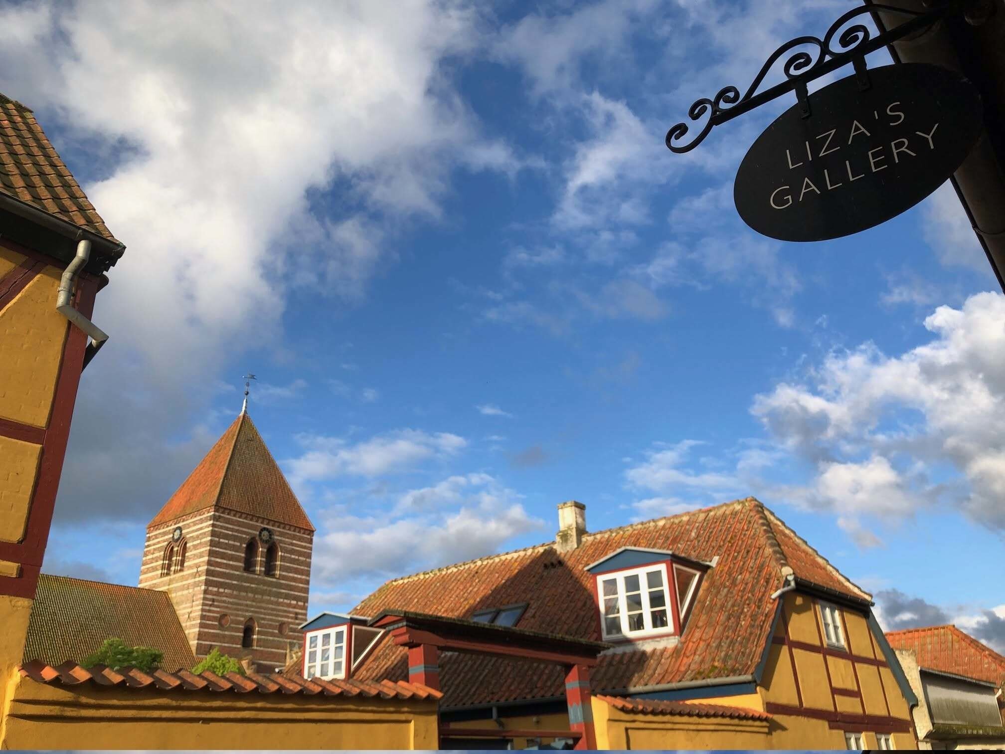 Low angle of the "Liza's Gallery" sign with blue sky. Liza's Gallery in Stege, Møn, Denmark.