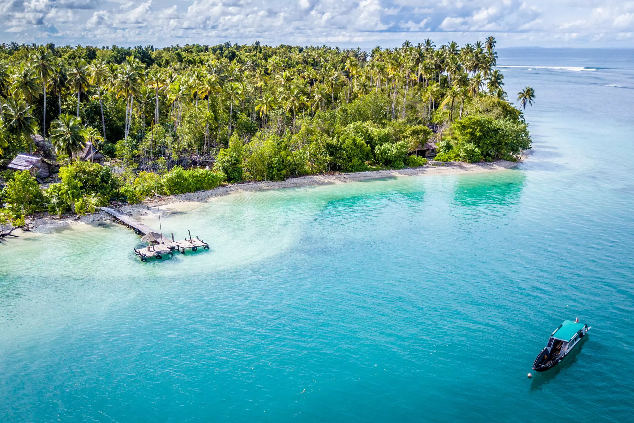 A boat off the shore of one of the Mentawai Islands, Sumatra, Indonesia.