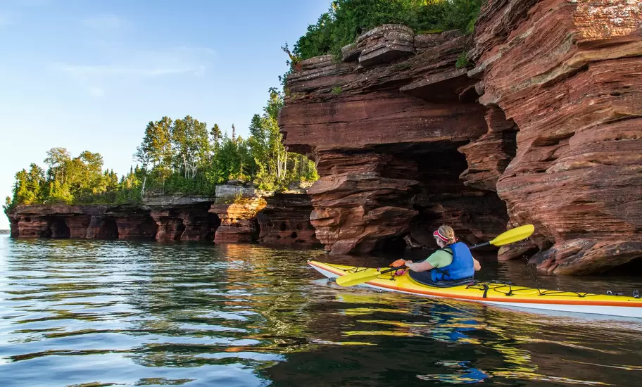 Kayaker exploring sea caves of Devils Island in Apostle Islands National Lakeshore, Wisconsin