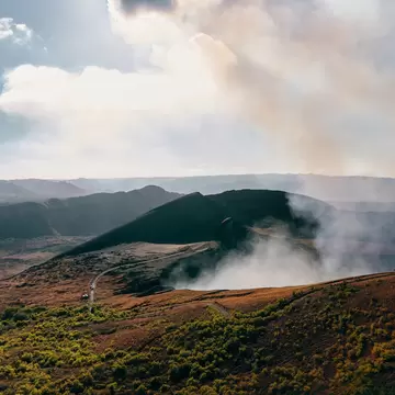 Steam rising out of an active volcano.