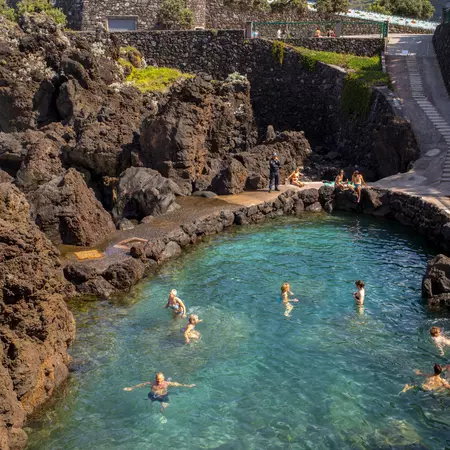 Swimmers in Porto Moniz natural rock pool