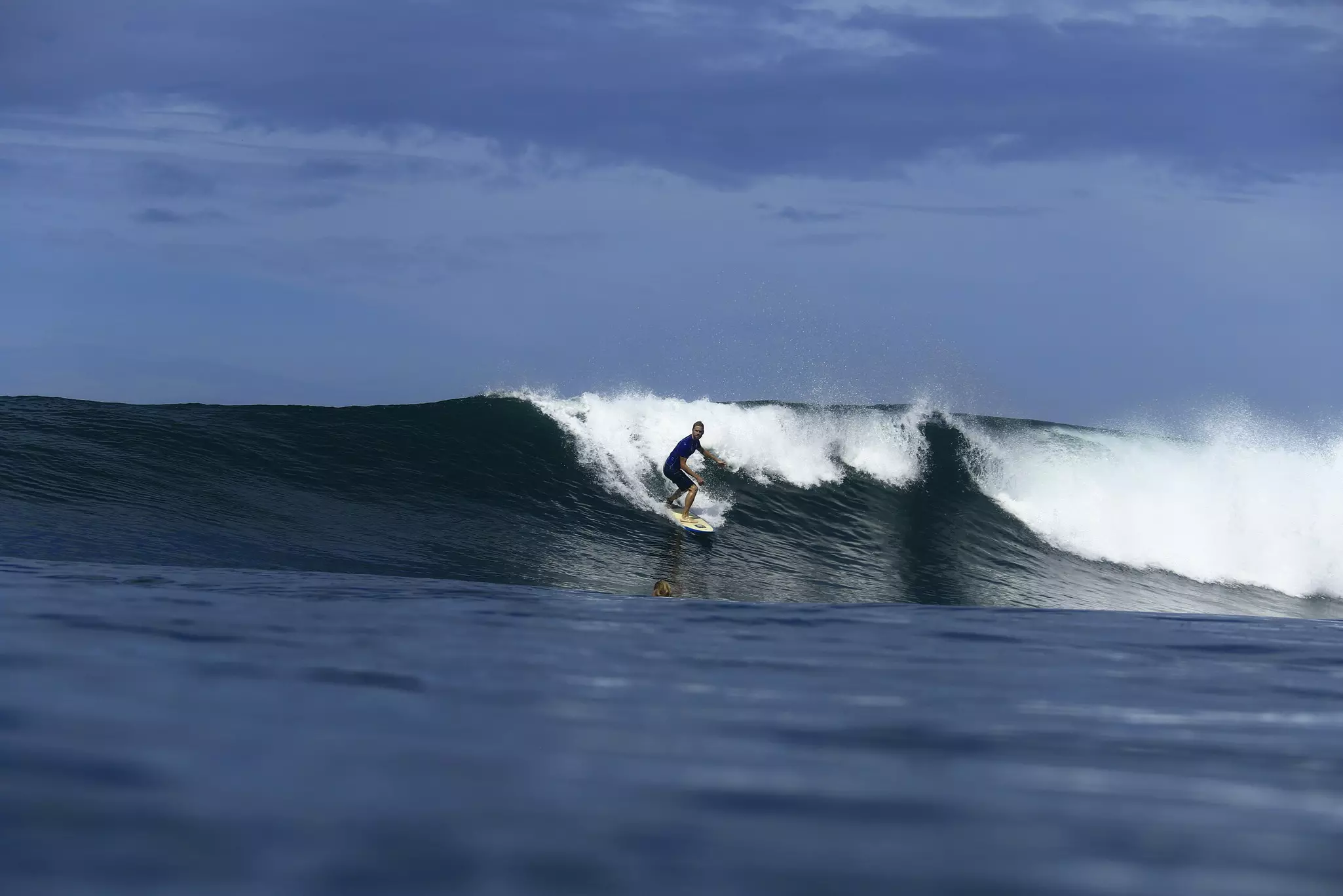 A surfer ridinng a wave.