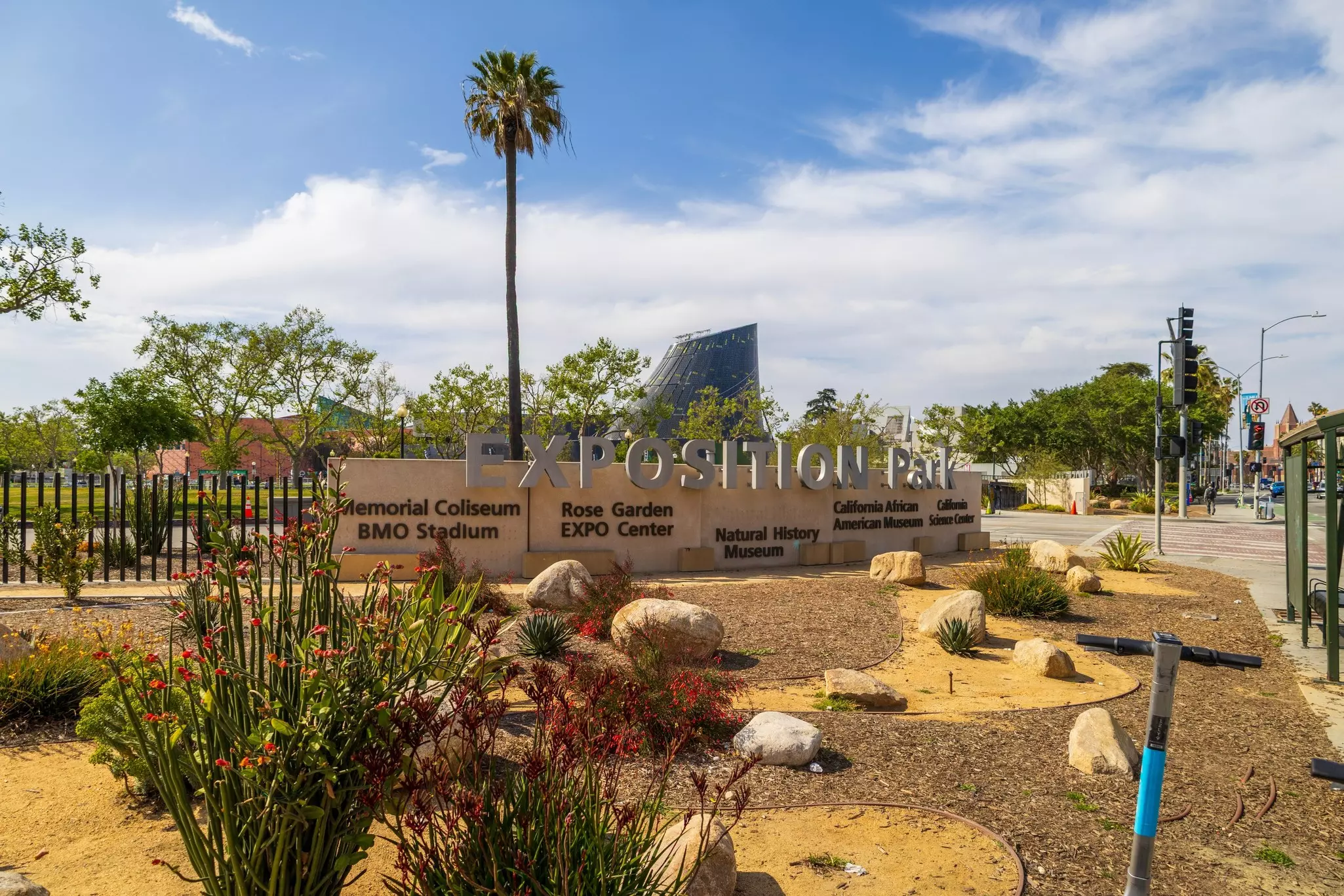 The Exposition Park sign with lush green trees in Los Angeles California USA