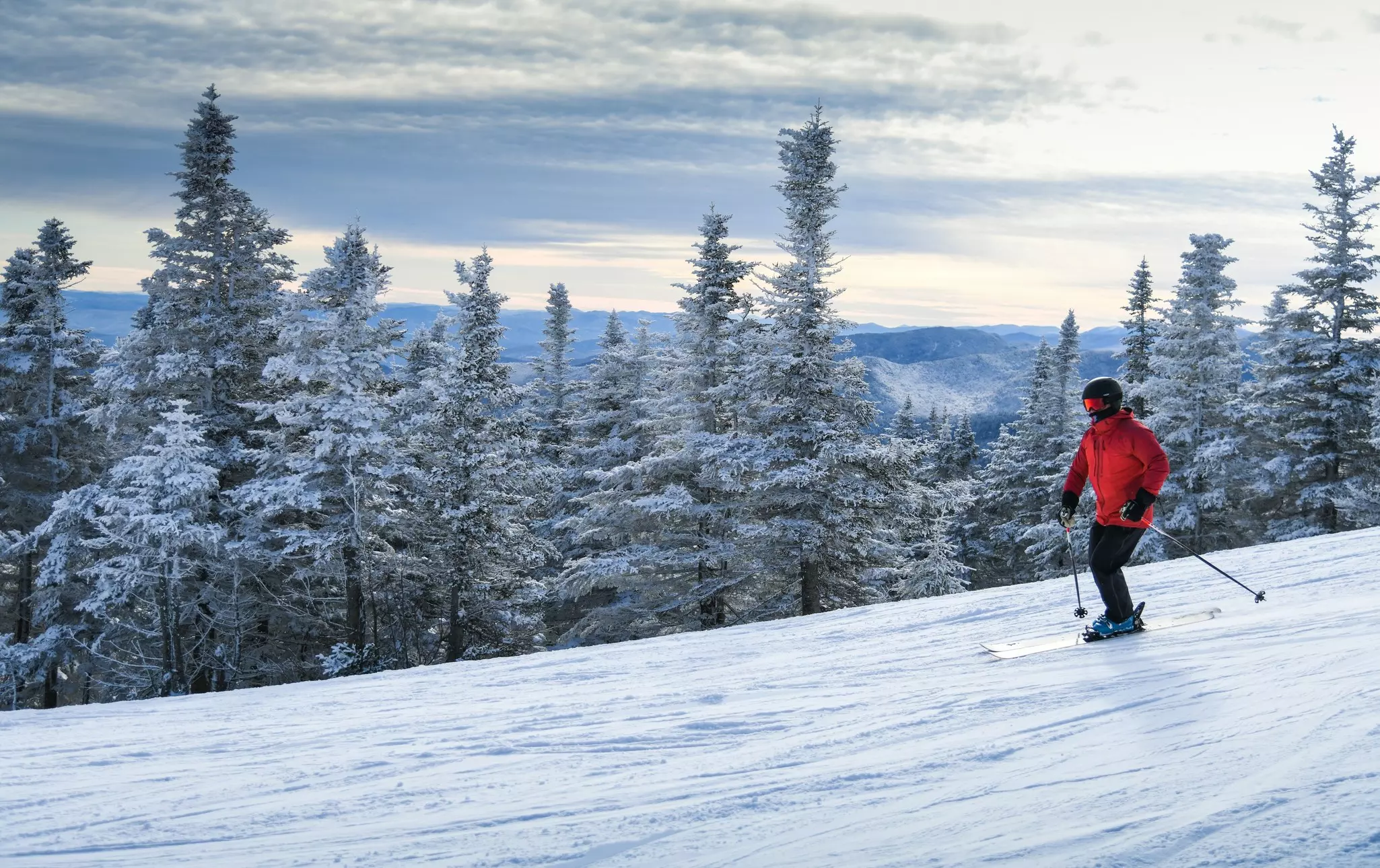 Male skier in red jacket enjoy skiing during winter vacation at Stowe Mountain Resort in Vermont. Active lifestyle concept.  License Type: media  Download Time: 2023-02-25T12:45:56.000Z  User:   Is Editorial: No  purchase_order: