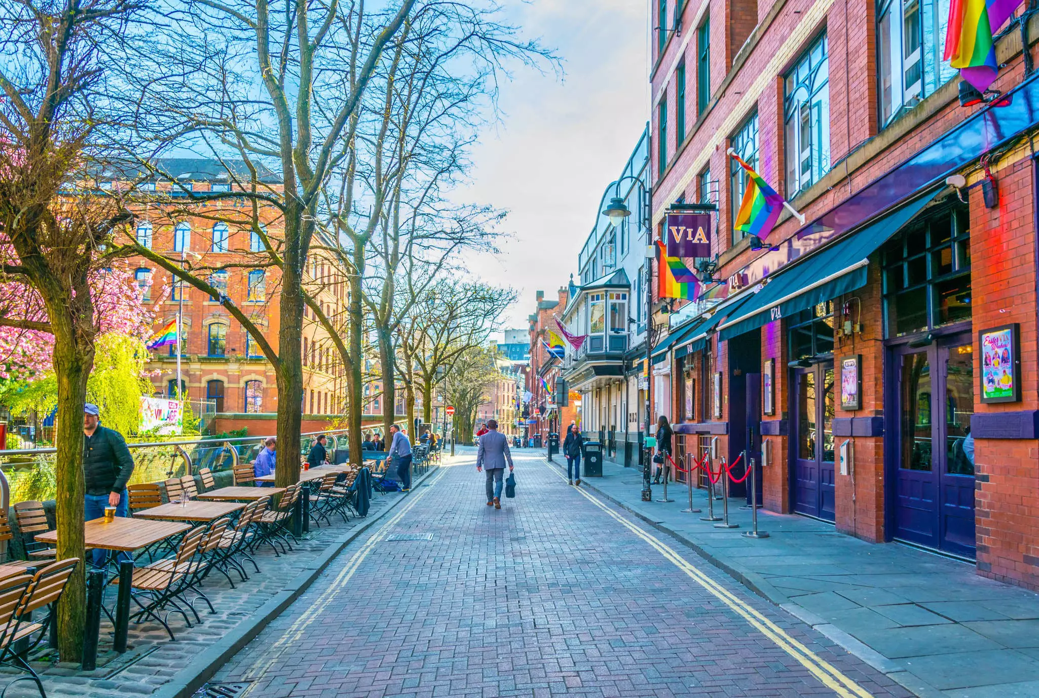 People walking in Gay Village alongside Canal street in Manchester, England