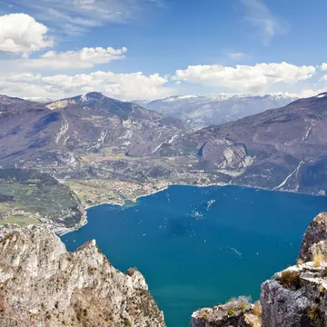 Climber on the Cima Rocca, via ferrata with view of Lake Garda, Riva and Nago-Torbole, Trentino, Italy, Europe