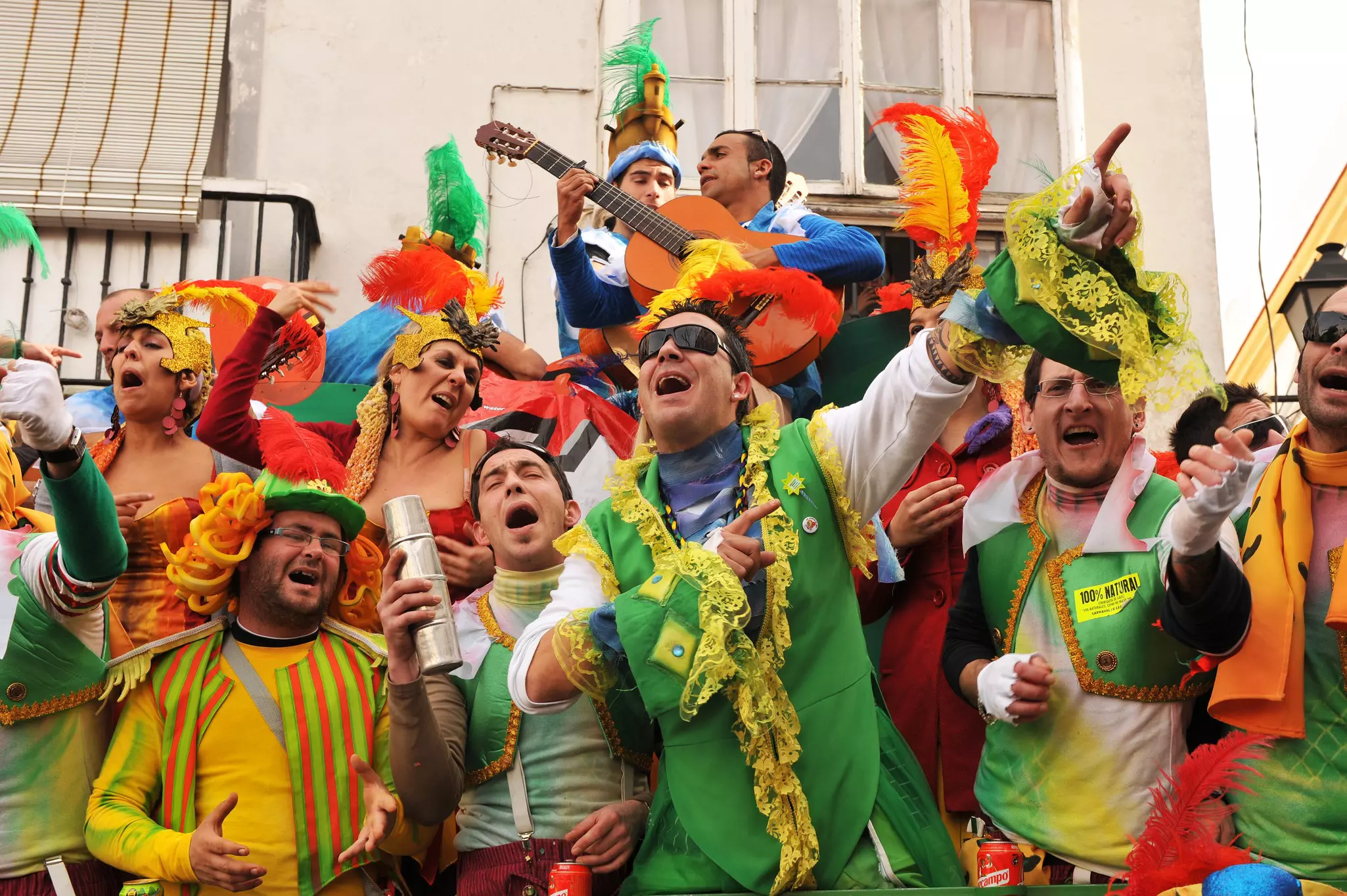 Revelers, dressed predominantly in green with elaborate head wear, sing during the famous Carnaval of Cadiz, Andalusia, Spain.