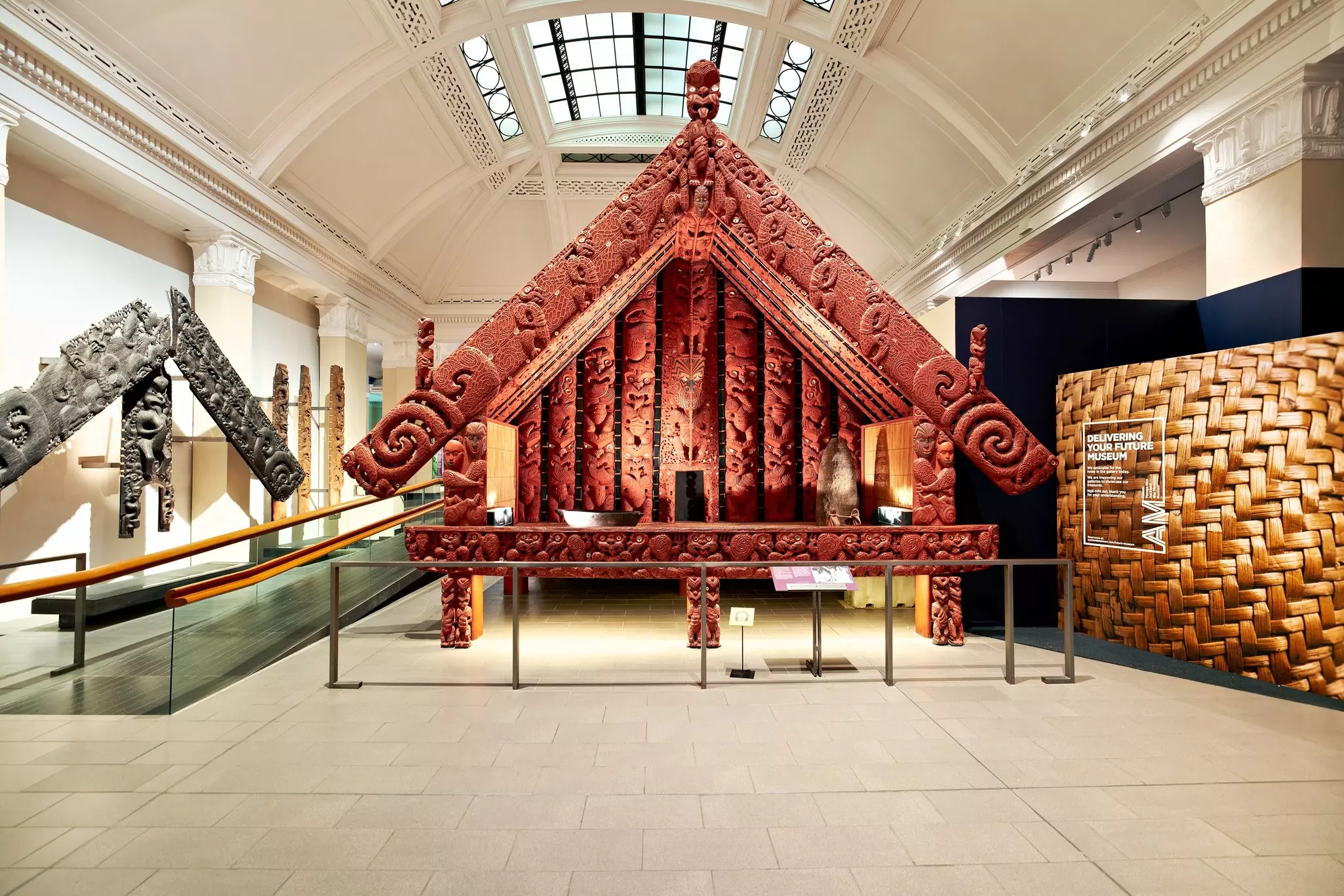 Carved Māori works on display in a museum gallery in Auckland, New Zealand.