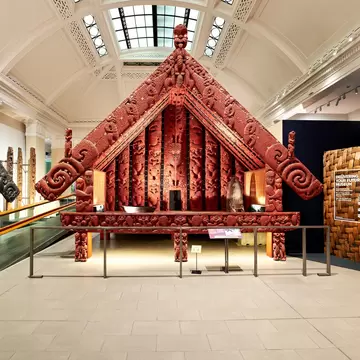 Carved Māori works on display in a museum gallery in Auckland, New Zealand.