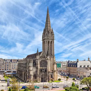 Church of Saint-Pierre in Caen, with streaks of white cloud in the sky.