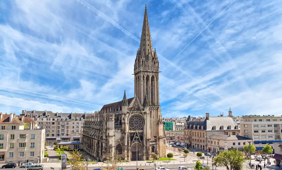 Church of Saint-Pierre in Caen, with streaks of white cloud in the sky.