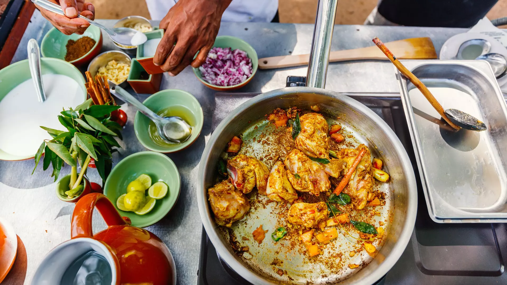 Preparation of traditional Sri Lankan curry dish with tender chicken breast at cooking class