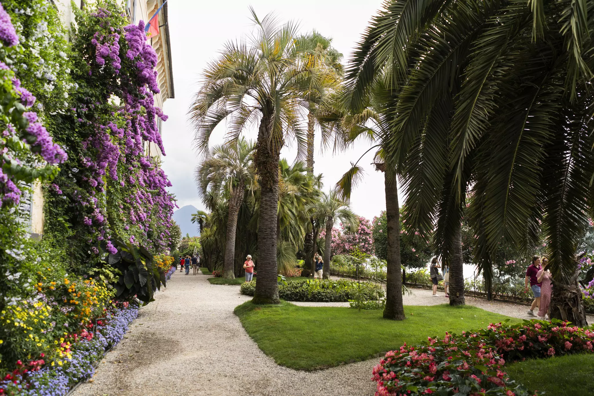 Tourists wander around the lush gardens of an old mansion on Lake Maggiore in Italy.
