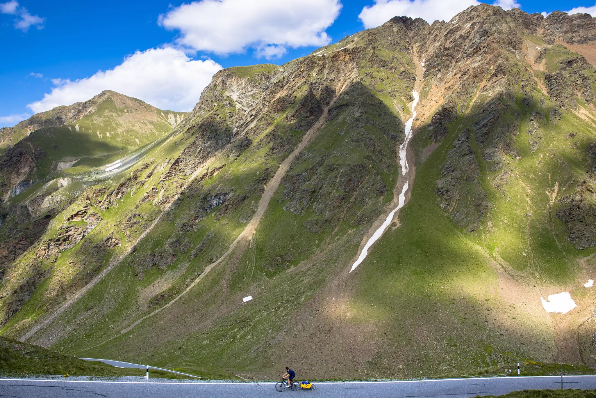 Cyclist on Umbrail Pass in the Alps, Switzerland