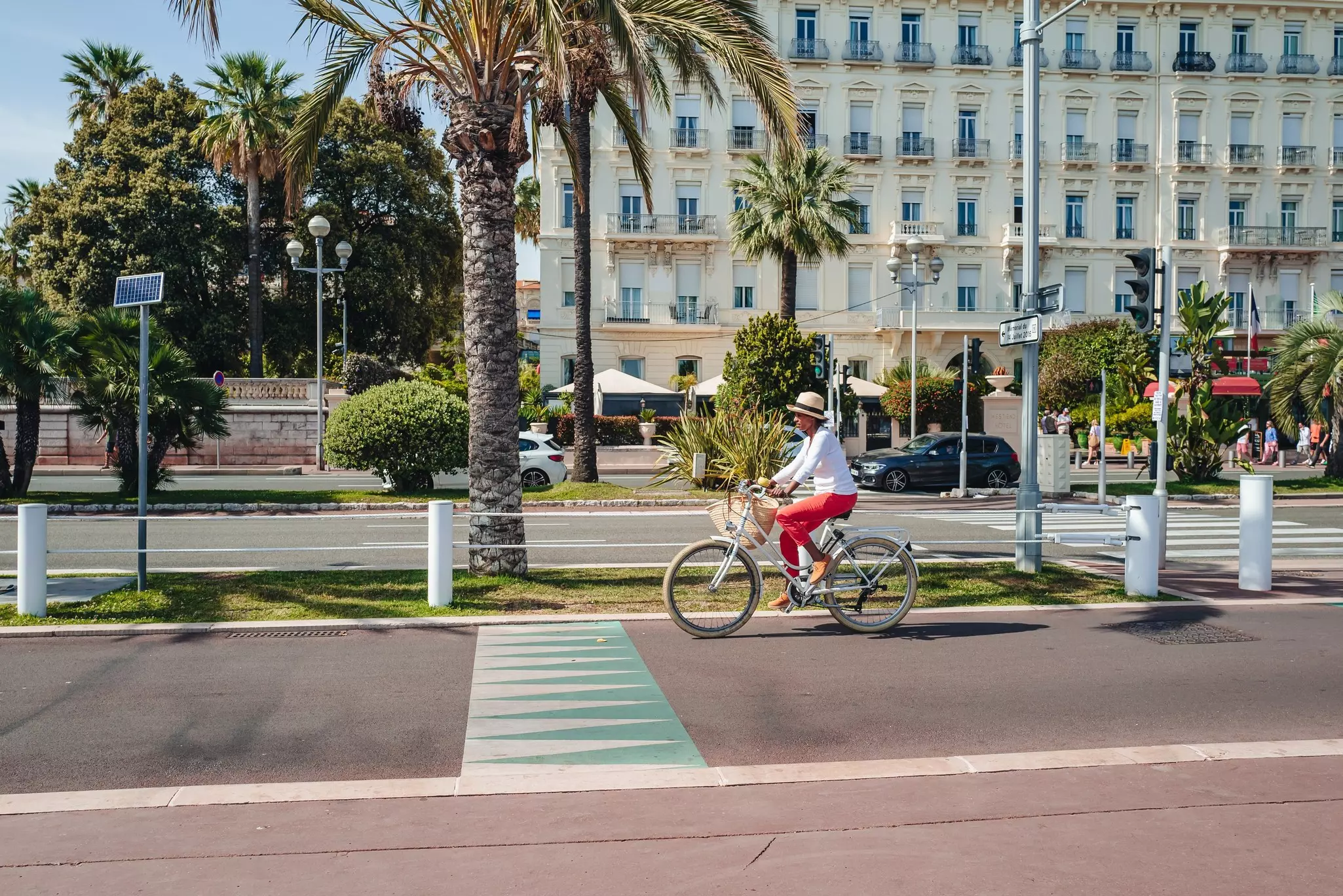 Cycling along the Promenade des Anglais pedestrian area by the beach.