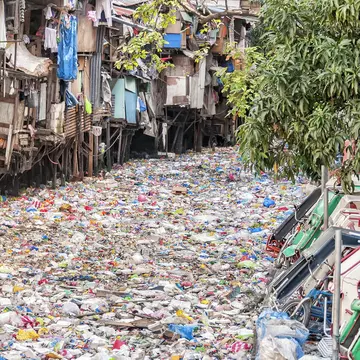 Shanties on stilts standing on a polluted river in the Philippines (stock photo) Getty Images