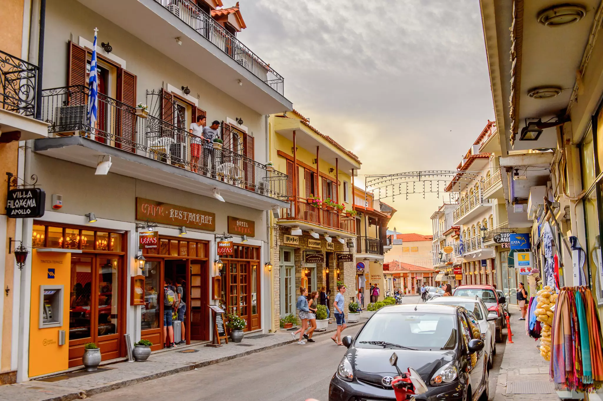 A street in a small town lined with cafes, restaurants and stores.