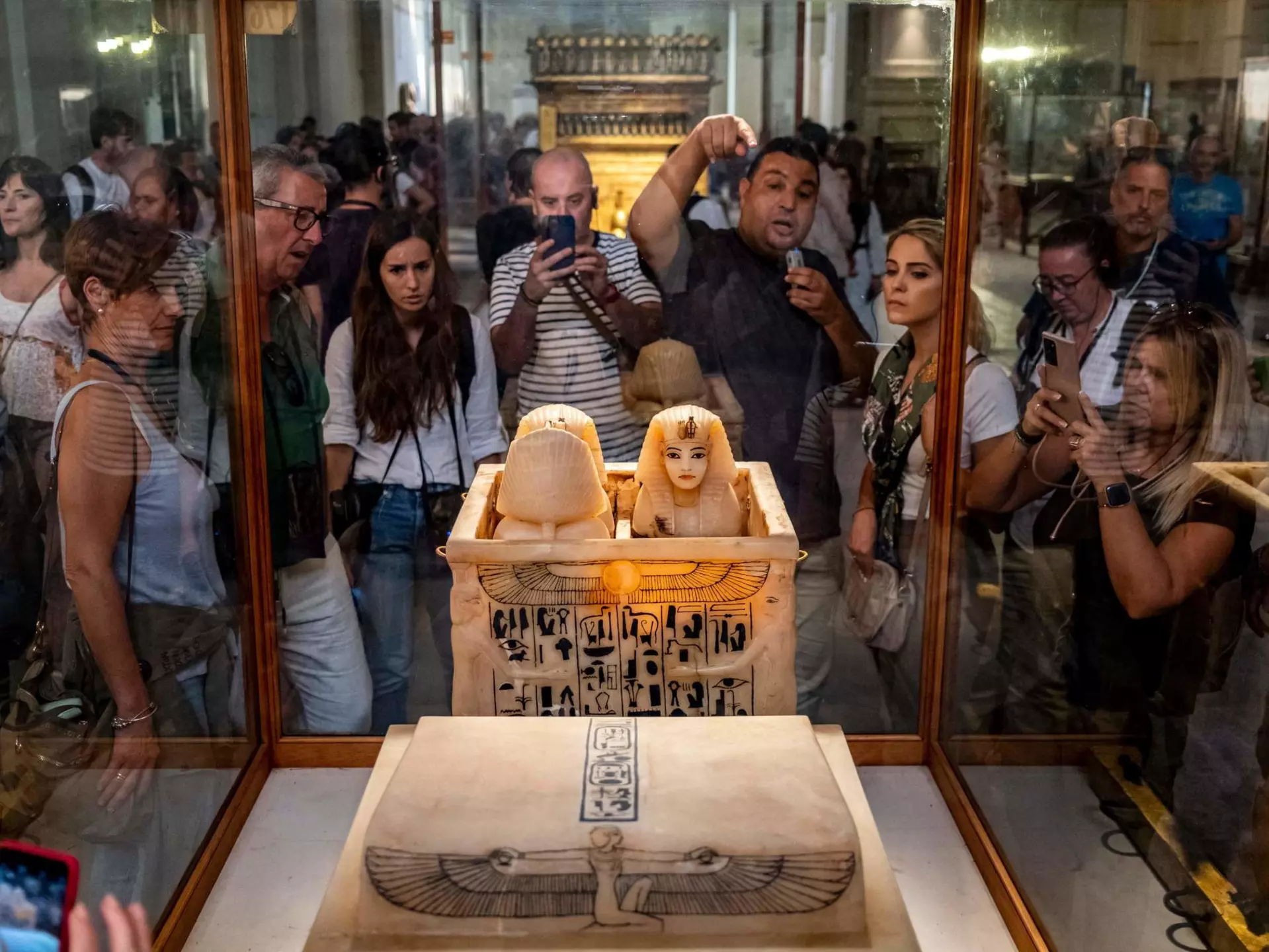 A guide briefs tourists before canopic jars which contained the organs of the ancient Egyptian New Kingdom Pharaoh Tutankhamun (1332-1323 BC) at his tomb KV62, displayed with the Tutankhamun collection at the Egyptian Museum in the centre of Egypt's capital Cairo on November 6, 2022. - The resting place of Egypt's pharaoh Tutankhamun has become the world's most famous tomb, its discovery 100 years ago among the greatest archaeological discoveries of all time.