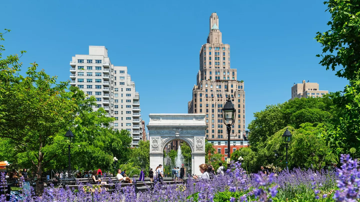 Washington Square Park in Manhattan with the iconic landmark arch and visitors enjoying a sunny spring morning