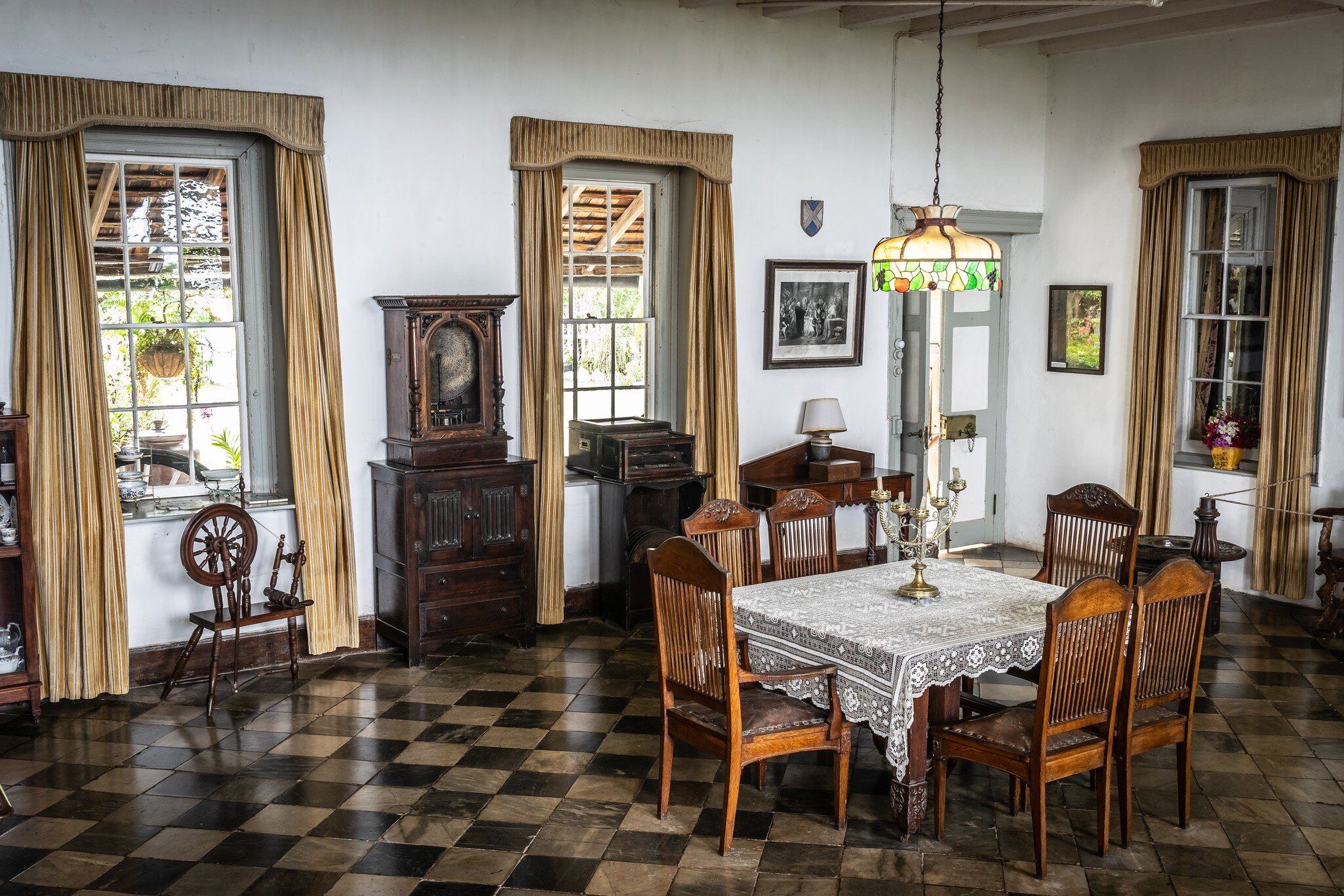 Montego Bay, Jamaica - June 06 2015: Greenwood Great House Antique Museum. Vintage furniture in dining room area inside antique mansion in the Caribbean. Checkered flooring, 6 seat table, chandelier.; Shutterstock ID 1122712505;